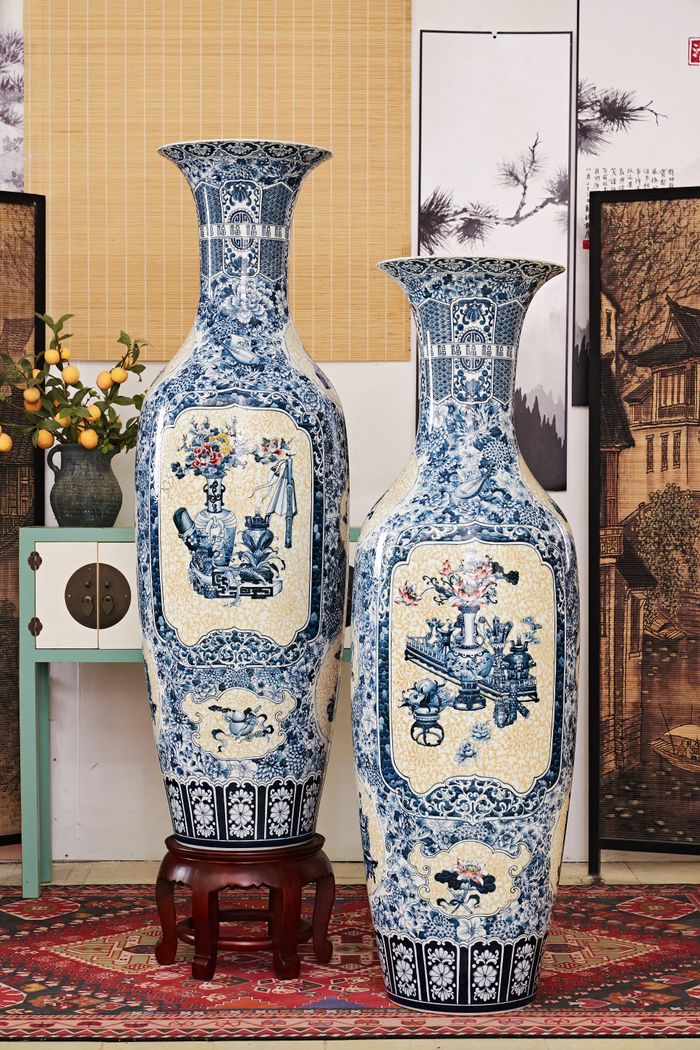 Elegant blue and white ceramic vases with intricate patterns in an interior setting.