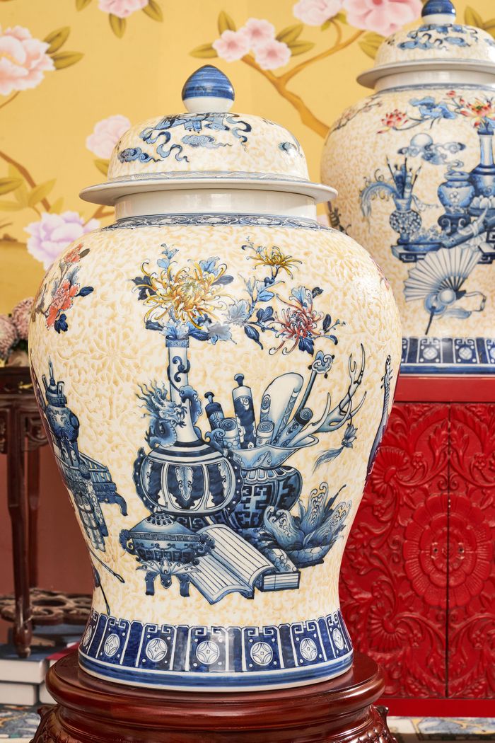 Blue and white porcelain vases featuring intricate floral designs showcased in a classic indoor setting.