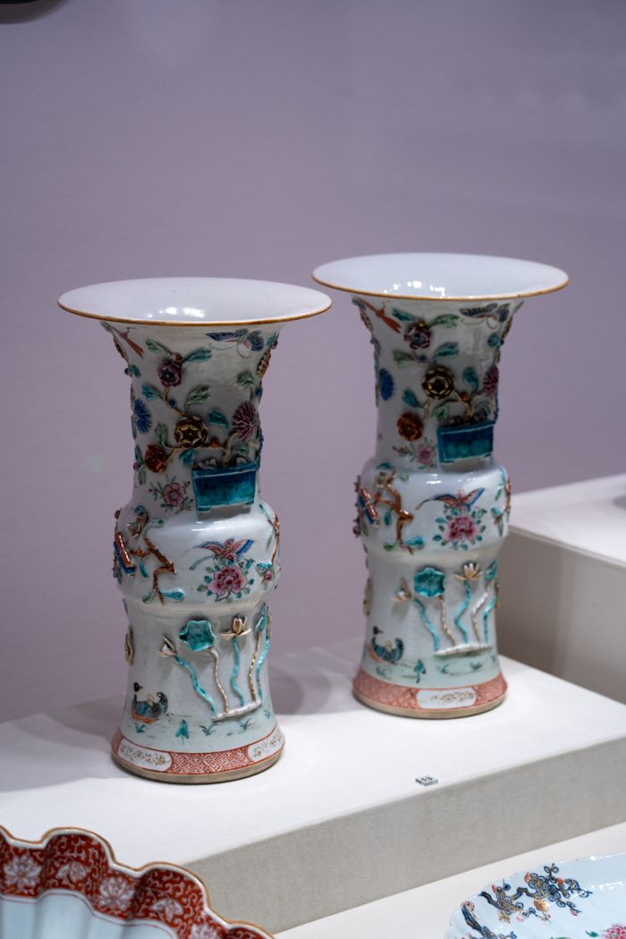 Exquisite Chinese porcelain vases with intricate designs displayed in a museum setting.
